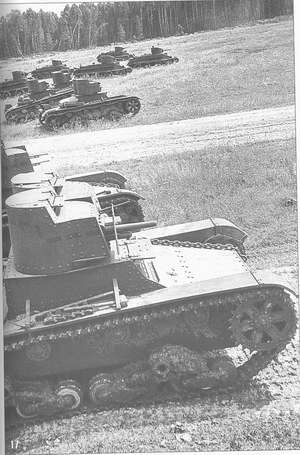 Double-turreted T-26 tank with gun-machine-gun armament is at the manoeuvres.