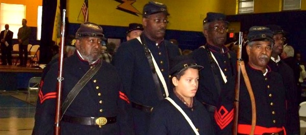 Members of the 12th U.S. Colored Heavy Artillery present the colors at the memorial ceremony. The unit is a living history and educational outreach program founded in 2001.