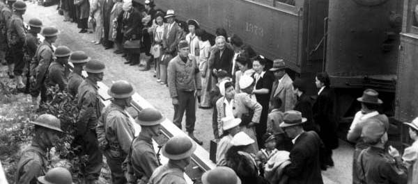 April 5, 1942. Persons of Japanese ancestry arrive at the Santa Anita Assembly Center from San Pedro, Calif. Evacuees lived at this center at the former Santa Anita race track before being moved inland to relocation centers. (National Archives)
